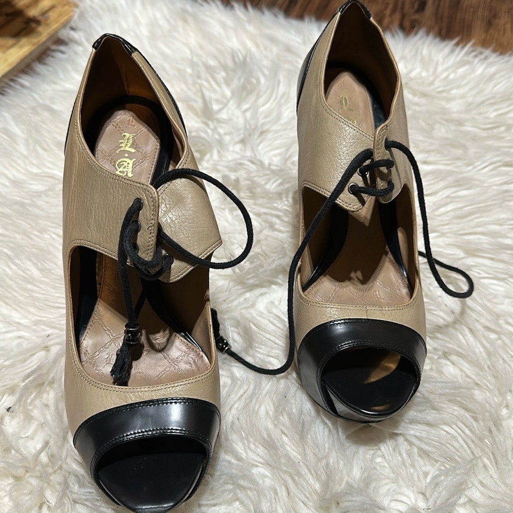 Black and tan color lock high heel shoes by LAMB Gwen Stefani.  Size 8.
